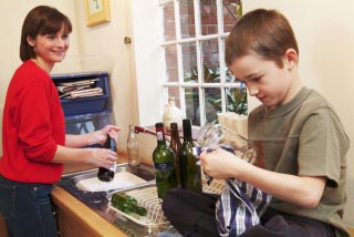 mother and son selecting bottles for recycling